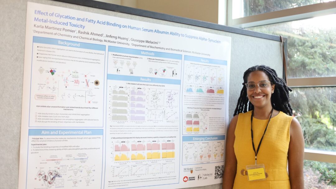 Photo of Karla standing next to her poster presentation board