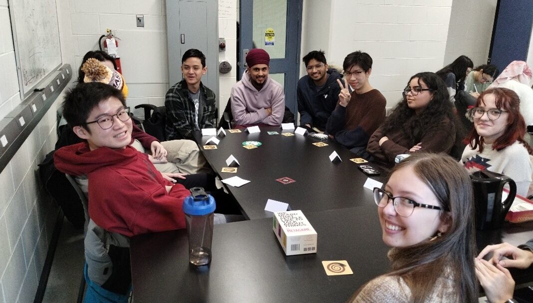Photo of a group of students sitting around a table playing boardgames